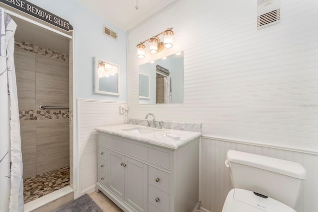 bathroom featuring vanity, toilet, and curtained shower