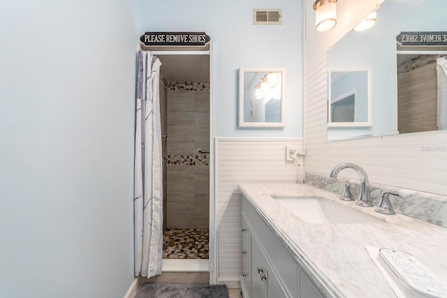 bathroom with vanity and walk in shower