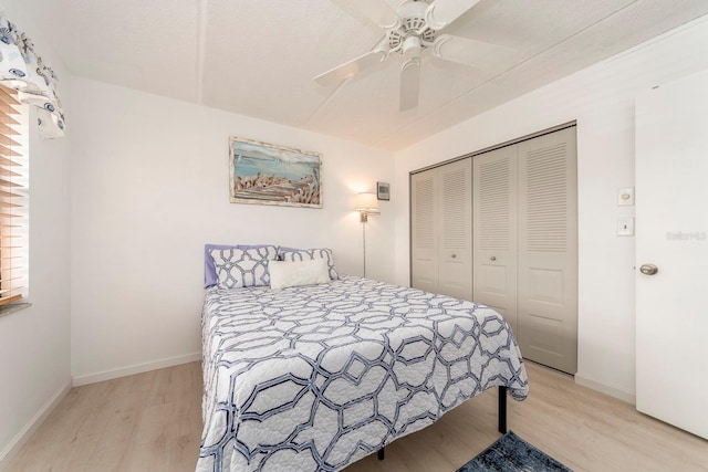 bedroom with ceiling fan, a closet, and light wood-type flooring