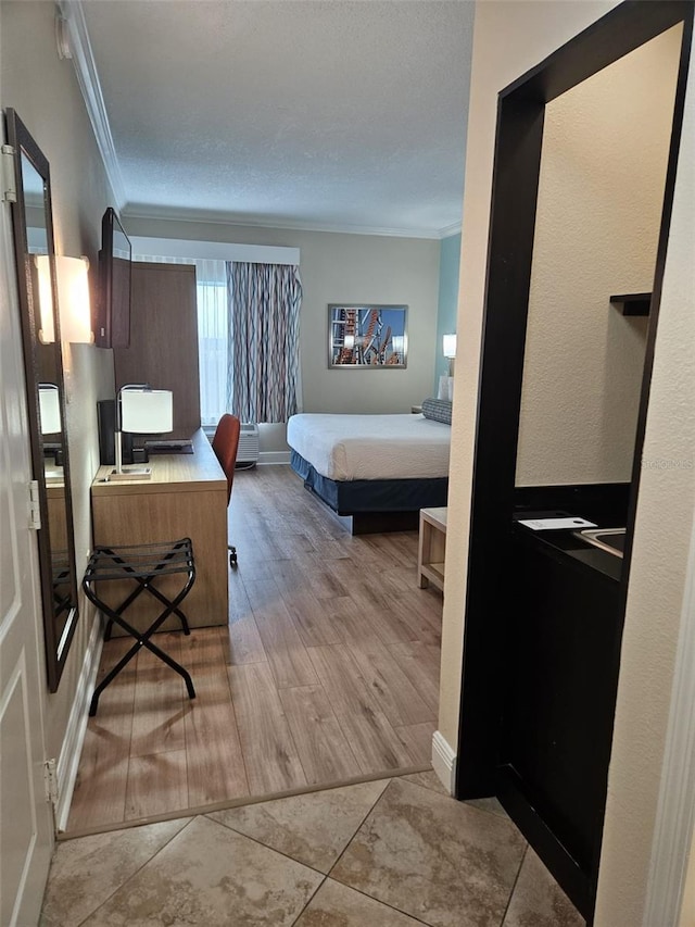 interior space with crown molding and light tile floors