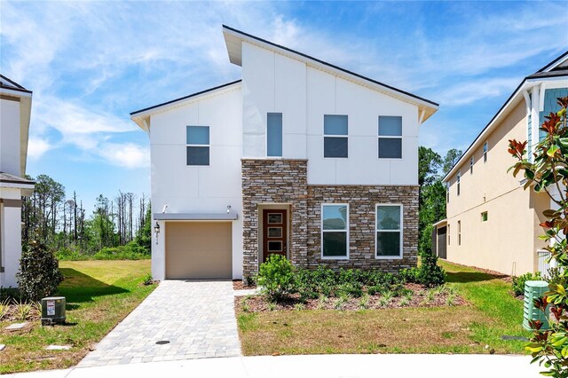 view of front of house with a garage and a front lawn