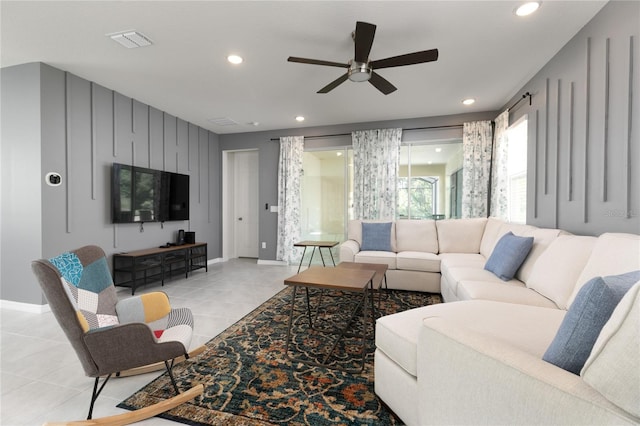 living room with light tile patterned flooring and ceiling fan