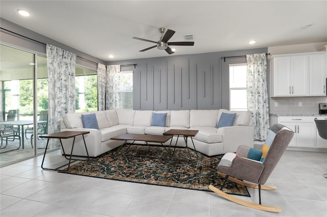 living room featuring light tile patterned floors and ceiling fan