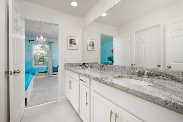 bathroom featuring vanity, a notable chandelier, and tile patterned flooring