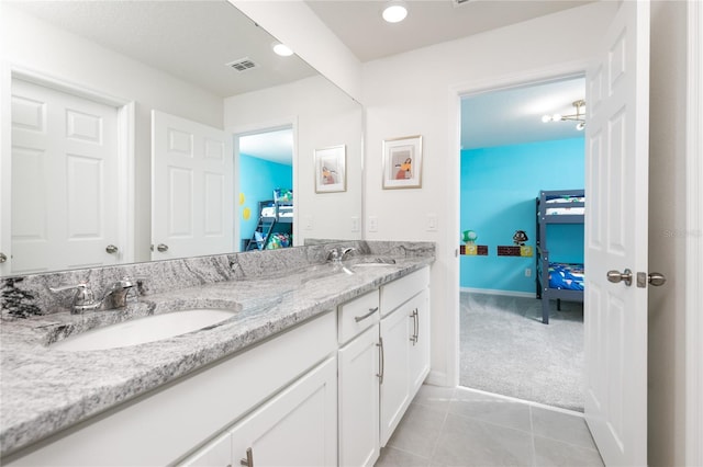 bathroom with tile patterned floors and vanity