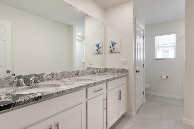 bathroom featuring vanity, tile patterned flooring, and toilet