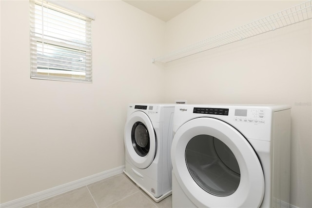 laundry room with light tile patterned floors and washing machine and clothes dryer