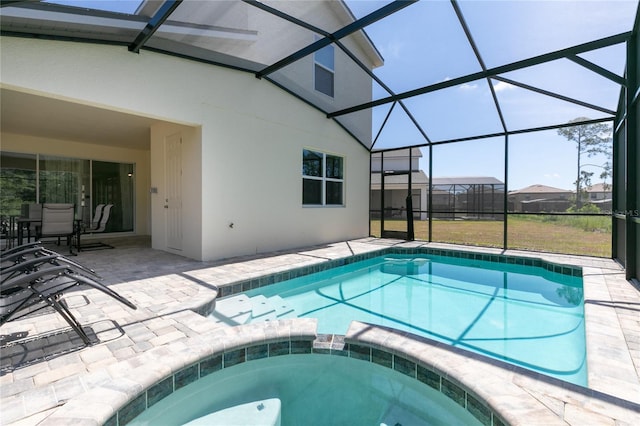 view of pool with an in ground hot tub, a lanai, and a patio area