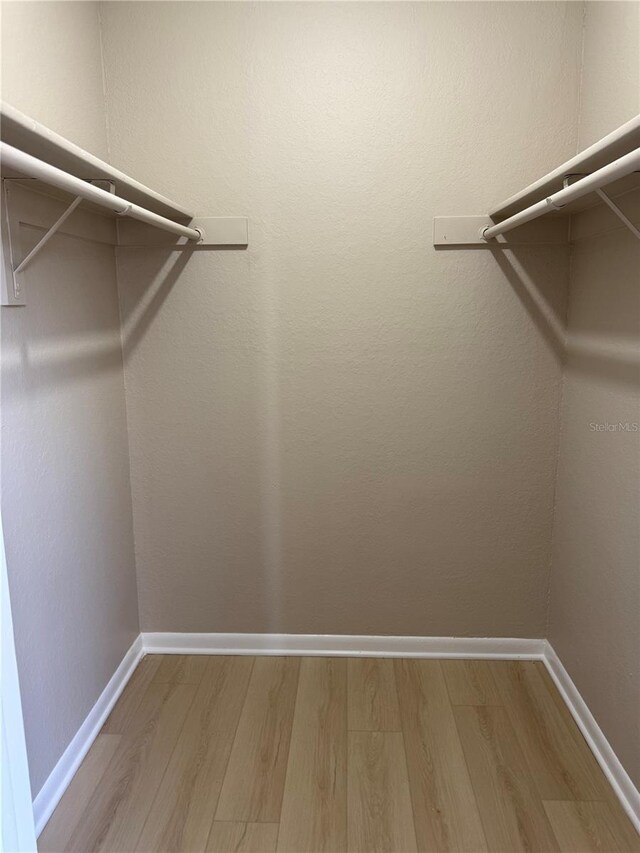 5635 Devonbriar Way Unit 103, Orlando, FL 32822 - spacious closet with wood finished floors
