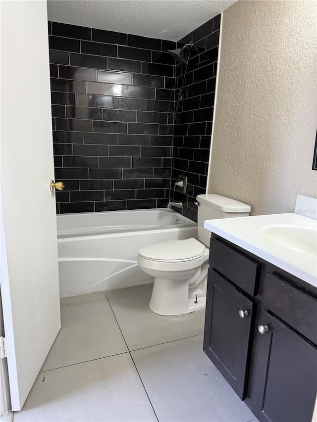 5635 Devonbriar Way Unit 103, Orlando, FL 32822 - full bathroom with bathtub / shower combination, tile patterned floors, toilet, a textured wall, and vanity
