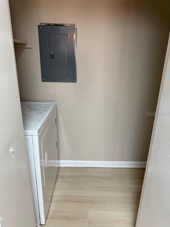 5635 Devonbriar Way Unit 103, Orlando, FL 32822 - laundry room with independent washer and dryer, light wood-style floors, electric panel, laundry area, and baseboards