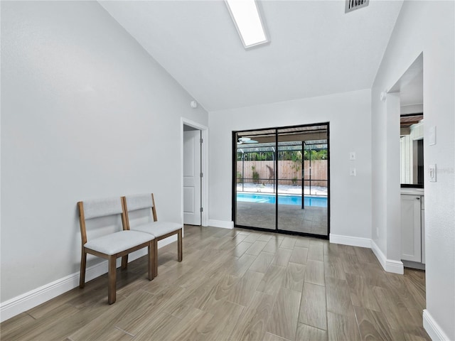 sitting room with vaulted ceiling