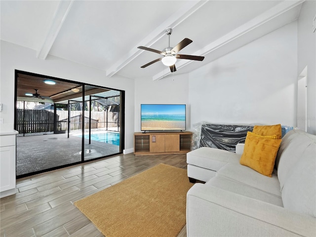 living room featuring ceiling fan and beamed ceiling