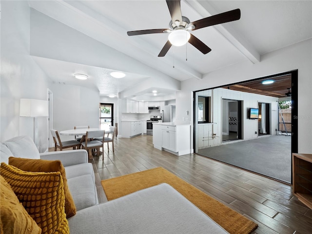 living room featuring lofted ceiling with beams and ceiling fan