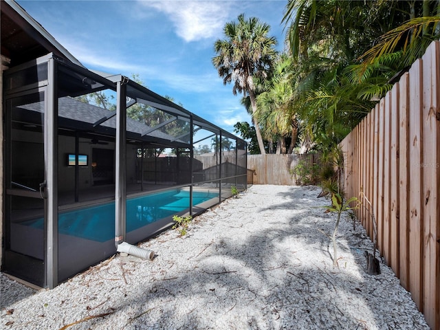 view of pool with a lanai and a patio