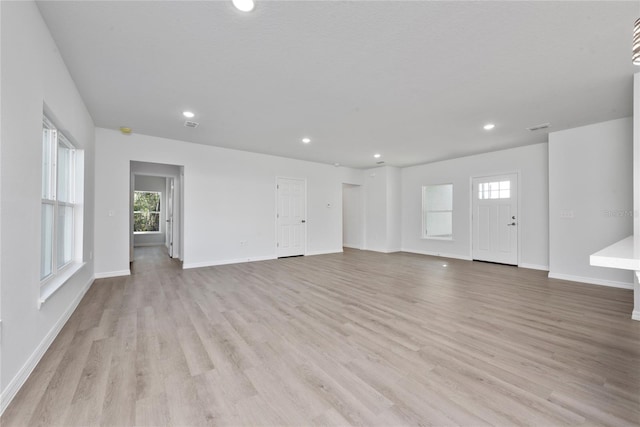 unfurnished living room featuring light hardwood / wood-style flooring