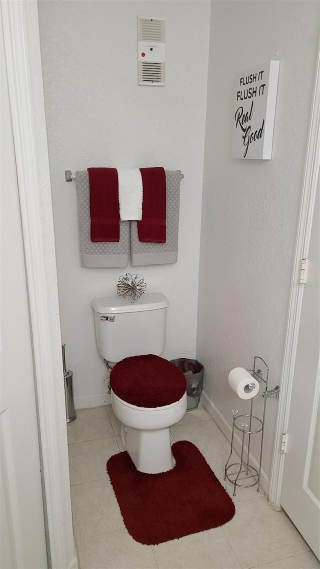 bathroom with toilet and tile patterned floors