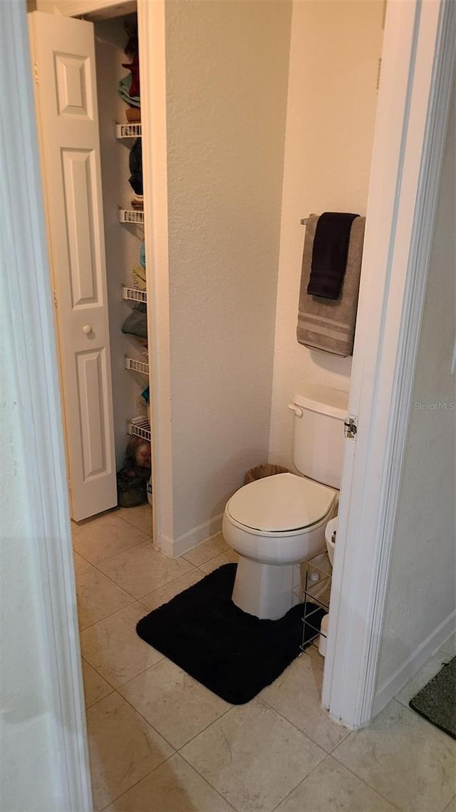 bathroom featuring tile patterned flooring and toilet