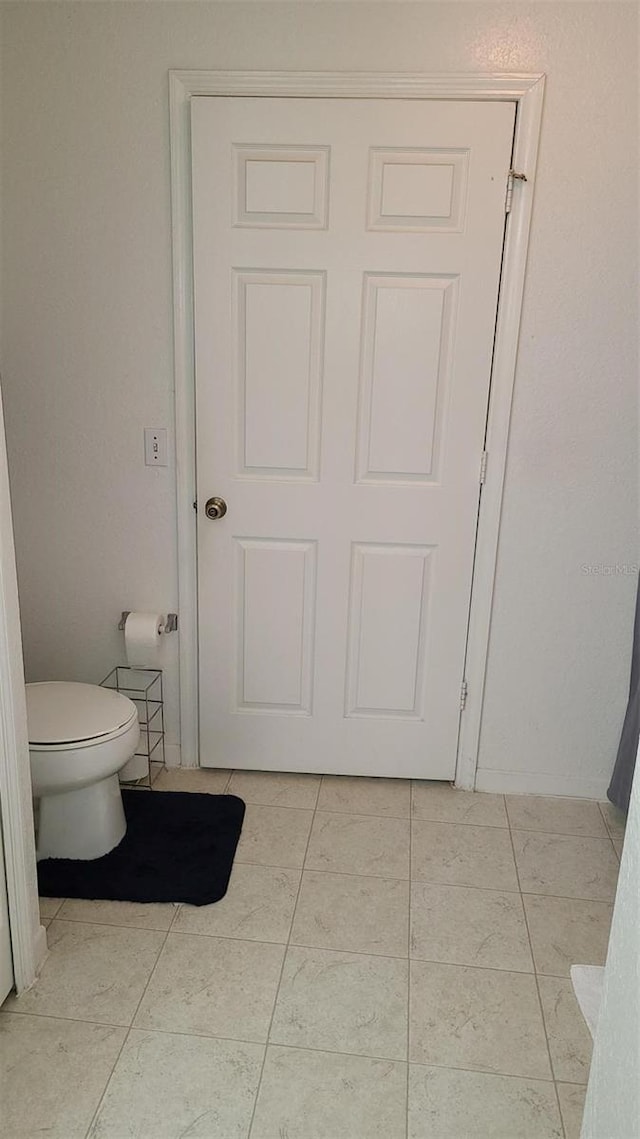 bathroom featuring tile patterned flooring and toilet