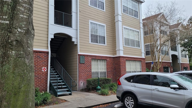 exterior space featuring brick siding and stairway