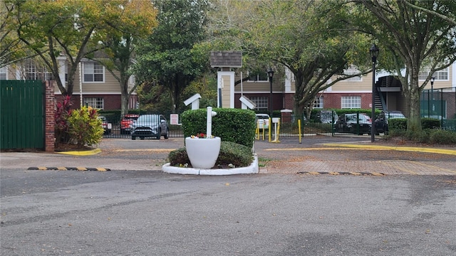 view of road with a gated entry and street lights