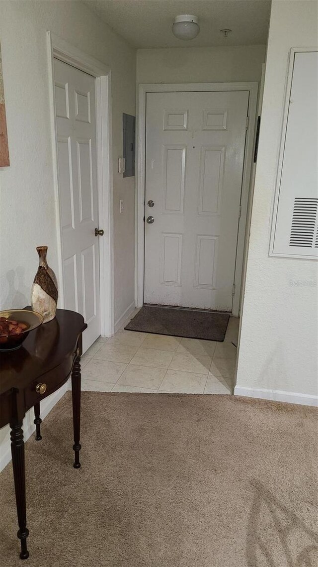 13103 Mulberry Park Dr Unit 824, Orlando, FL 32821 - foyer featuring light colored carpet, baseboards, electric panel, and light tile patterned flooring