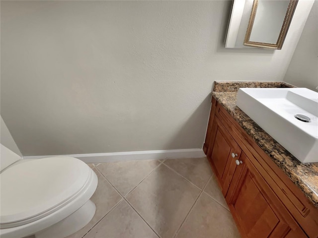 bathroom with tile floors, toilet, and vanity