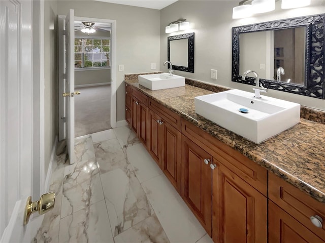 bathroom featuring tile floors, oversized vanity, ceiling fan, and dual sinks