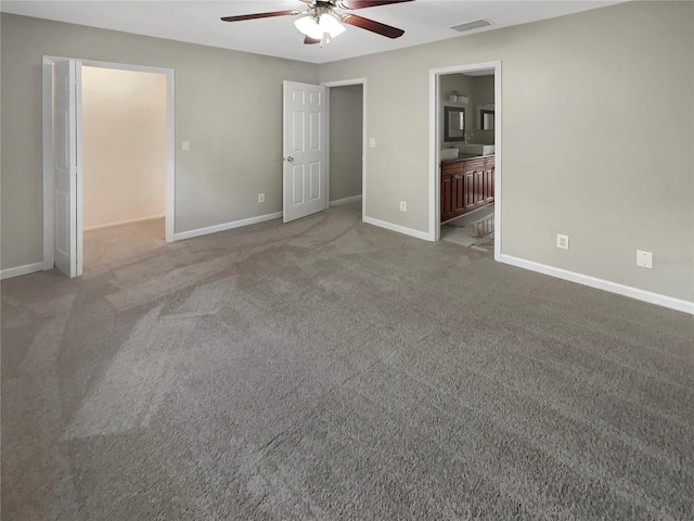 unfurnished bedroom with light carpet, connected bathroom, and ceiling fan