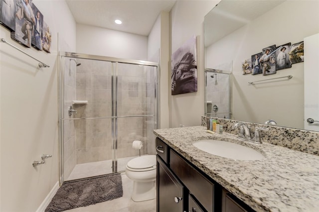 bathroom with toilet, tile flooring, walk in shower, and vanity