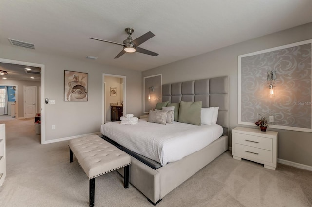 bedroom with light carpet, ceiling fan, and connected bathroom