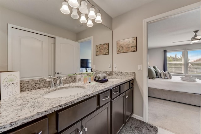 bathroom featuring double vanity and ceiling fan with notable chandelier