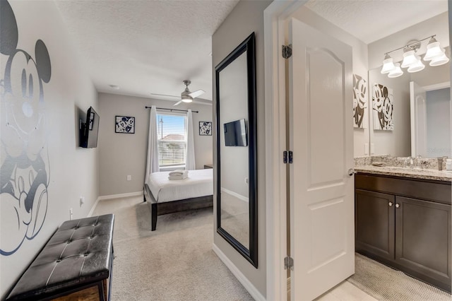 bathroom featuring a textured ceiling, vanity, and ceiling fan