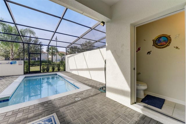 view of pool featuring a patio area and glass enclosure