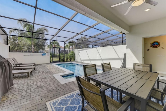 view of pool featuring a patio, ceiling fan, and glass enclosure