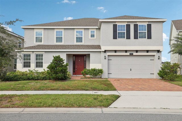 view of front of home featuring a front yard and a garage