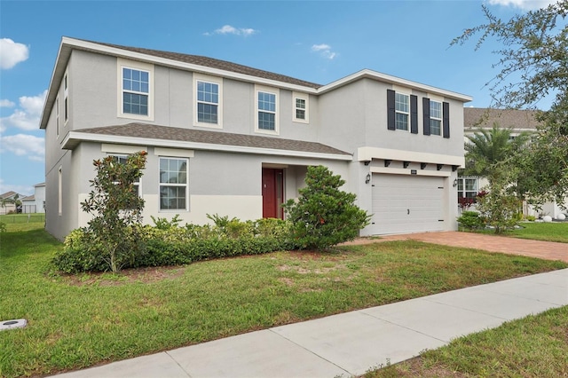 view of front of property with a front yard and a garage