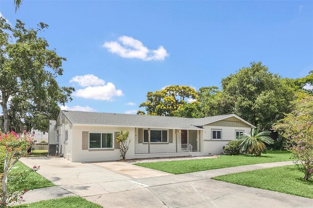 single story home with central AC unit and a front yard