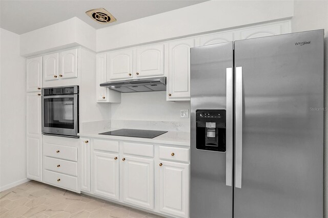 kitchen featuring appliances with stainless steel finishes, light stone counters, white cabinetry, and light tile patterned floors