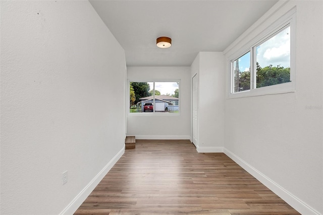 hallway with hardwood / wood-style flooring