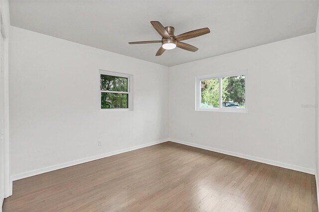 spare room with ceiling fan and wood-type flooring