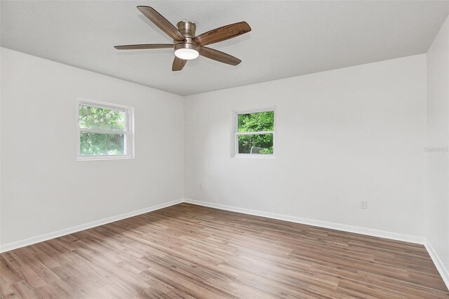 unfurnished room with ceiling fan and light hardwood / wood-style floors