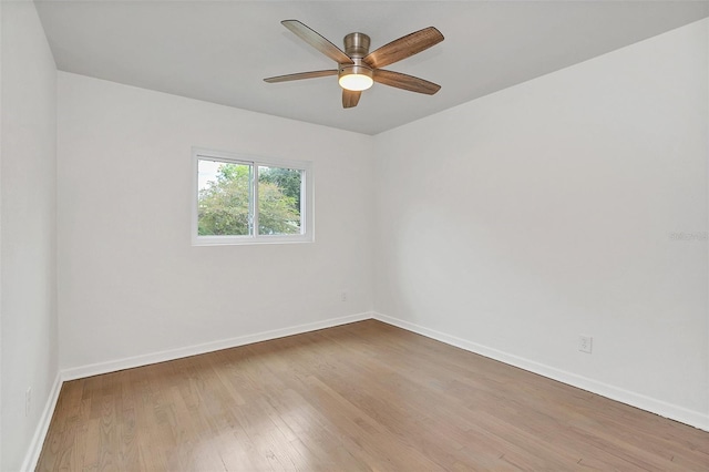 empty room with ceiling fan and hardwood / wood-style floors