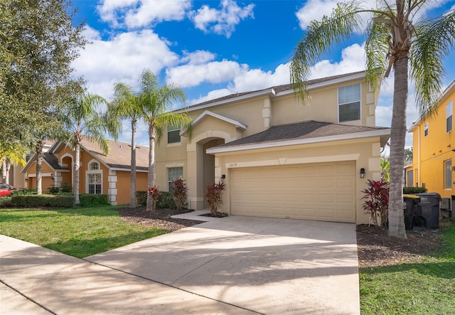 view of front of home with a front yard and a garage