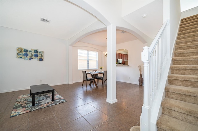 living area featuring dark tile flooring