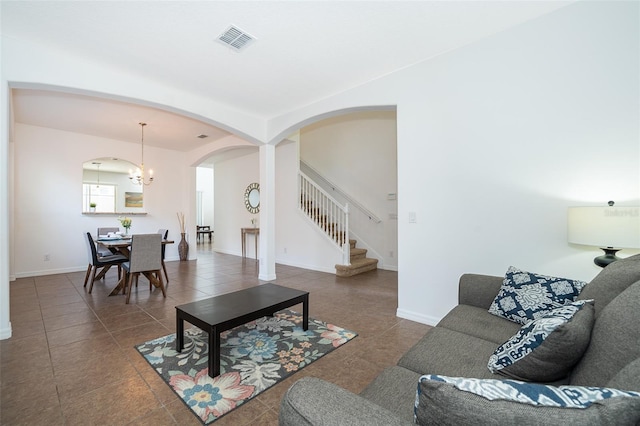 tiled living room featuring a chandelier