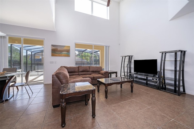 living room featuring light tile floors and a towering ceiling