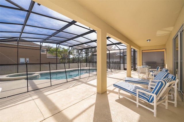 view of swimming pool featuring a patio area, an in ground hot tub, and glass enclosure