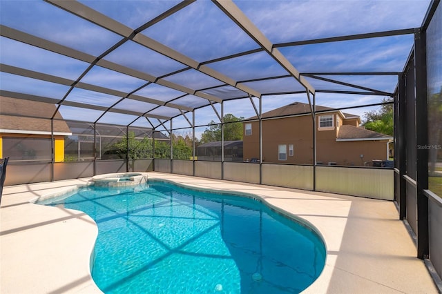 view of swimming pool featuring an in ground hot tub, a lanai, and a patio