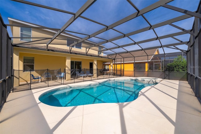 view of swimming pool with a patio area and glass enclosure